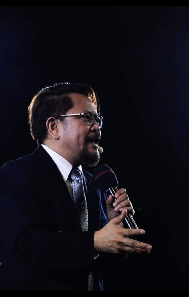 Pastor Jay Descalsota preaching at a BKK Global service